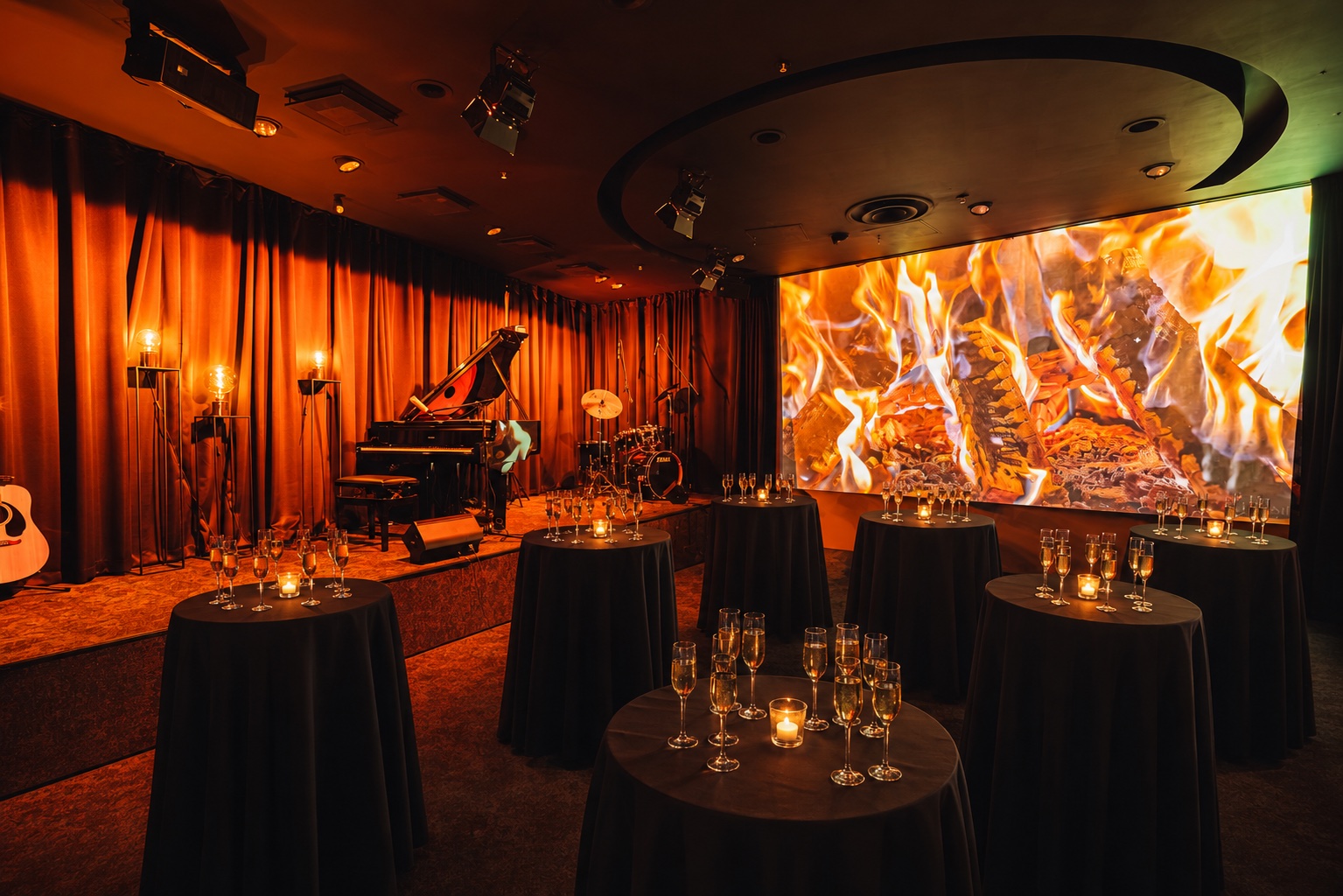 Downtown Piano Lab set for a private evening with cocktail tables, a stage, concert grand piano and large screen